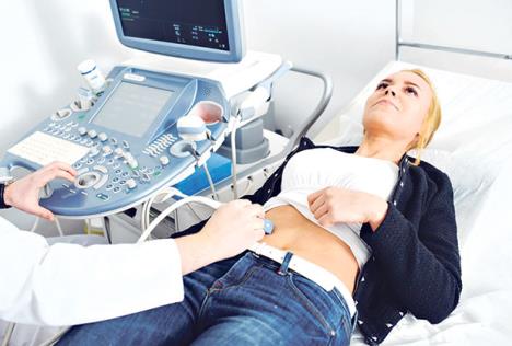 stockphotodoctormakesthepatientwomenabdominalultrasoundultrasoundscannerinthehandsofadoctor616374845.jpg