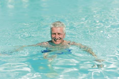 stockphotoseniormanswimminginpoolatresort190700522.jpg