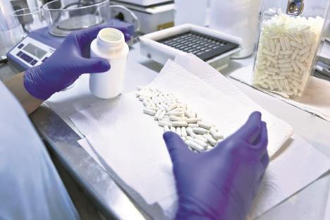 stockphotopackingwhitecapsulesinaboatinapharmaceuticallaboratoryspain360677720.jpg