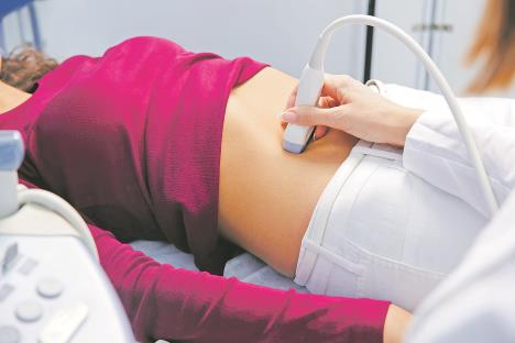 stockphotofemaledoctoroperatingultrasoundscannerexaminingbellyofherfemalepatient708261976.jpg