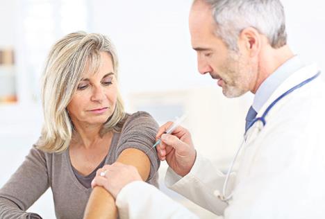 stockphotodoctorinjectingvaccinetoseniorwoman164560082.jpg