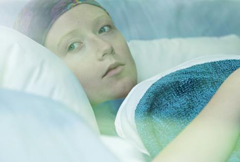 stockphotoyoungwomaninbedsufferingfromcancer429671722.jpg