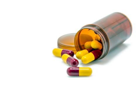 stockphotopillcapsulesantibioticsredandyellowonawhitebackground309812663.jpg