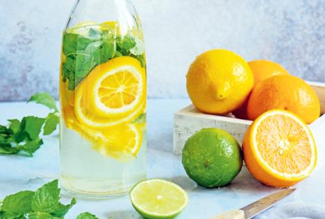 stockphotobottleofhomemadelemonadewithlemonorangelimeandmintlightgreyandbluestonebackground696874738.jpg