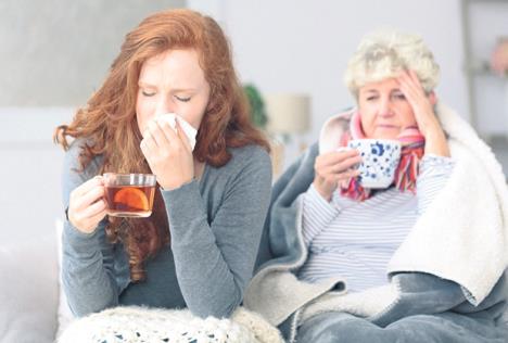 stockphotograndmotherandgranddaughtersittingtogetherwithcommonfluduringautumnweather753798817.jpg