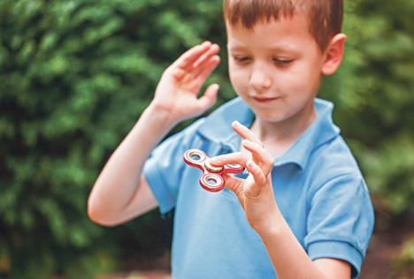 stockphotocutelittleboyplayingwithfidgethandspinnerinsummerdaypopularandtrendytoyforchildren667345636-copy.jpg