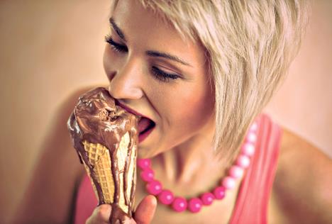 stockphotoyoungprettygirlwithshortblondhaireatingmeltingchocolateicecreamincone174475220.jpg