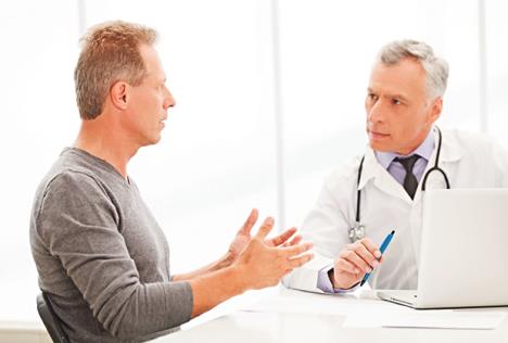 stockphotodoctorandpatientdoctorlisteningtothepatientwhileheistellingabouthisproblems144683051.jpg