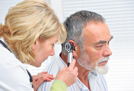 stockphotoentphysicianlookingintopatientsearwithaninstrument206475934.jpg