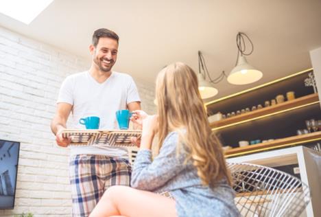 stockphotoportraitofayoungcoupleintheapartmentthemanisbringingcoffeetohisgirlfriend564694537.jpg