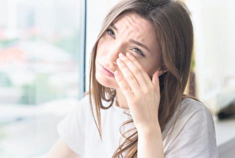 -stockphotoyoungsadwomansitsalonefrontofthewindowcryinggirlallergyillnessdepressionstress483378856.jpg