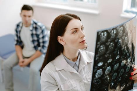 stockphotoseriousfemaleneurologistexaminingthexrayphoto629855189.jpg