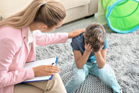 stockphotoyoungpsychologistworkingwithlittleboyinoffice729790102.jpg