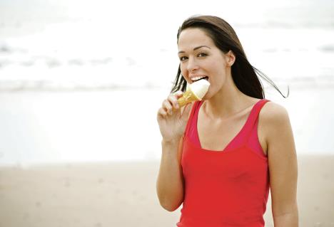 stockphotowomanlickingicecreamatthebeach61560733.jpg