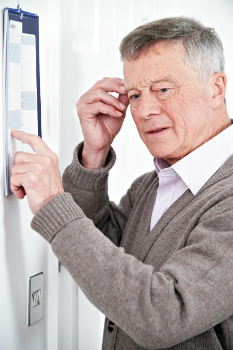 stockphotoconfusedseniormanwithdementialookingatwallcalendar376841650.jpg