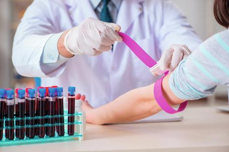 stockphotopatientduringbloodtestsamplingproceduretakenforanalysis1043902939.jpg