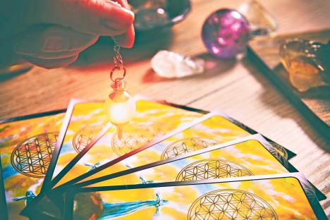 stockphototarotcardsdowsingtoolinhandandcrystalsasaconceptofpsychicadvisororwaysofdivination1028161645.jpg