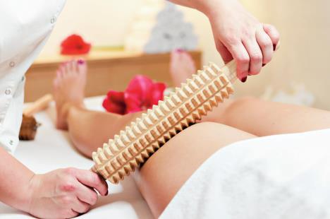 stockphotocloseupofwomanduringspaanticellulitemassagewithrollingpinorbattledore703983076.jpg