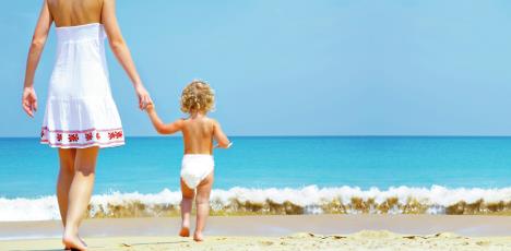 stockphotoportraitofyoungmotherwithherbabyhavingfunonthebeach13617691.jpg