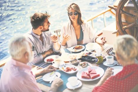 stockphotoattractivecoupleandtheirparentsenjoyingbreakfastonaboattopviewhorizontal1118322941.jpg