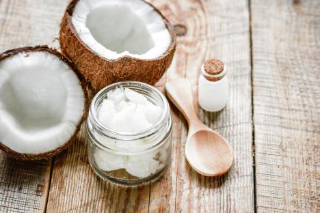 stockphotococonutoilforbodycareincosmeticconceptonoldwoodentable620187116.jpg