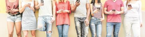 stockphotogroupofteenfriendswatchingsmartmobilephonesmillennialsgenerationaddictiontonew1119571079.jpg