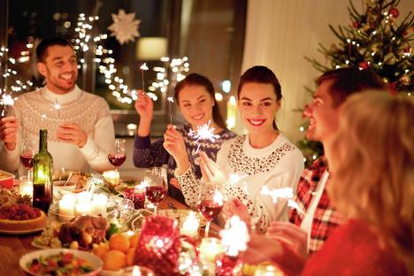 stockphotowinterholidaysandpeopleconcepthappyfriendswithsparklerscelebratingchristmasathome1186831723.jpg