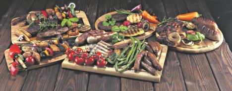 stockphotoassorteddeliciousgrilledmeatwithvegetableandherbsonrustictable1316431922.jpg