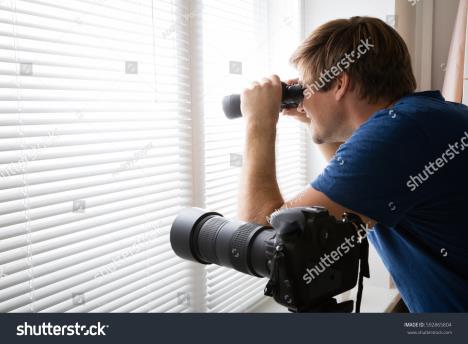 0402stockphotoprivatedetectivespyingwithbinocularslookingthroughblindsnearslrcamera592865804.jpg