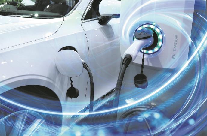stockphotoevcarorelectricvehicleatchargingstationwiththepowercablesupplypluggedinonblurred1668063934.jpg